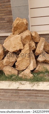 big and small rocks systematically arranged out side door for showpiece  Royalty-Free Stock Photo #2422539995
