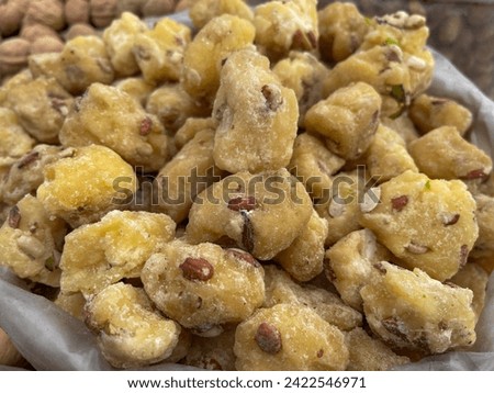 jaggery sugarcane mixed with dry fruit raw photo from front view with background blur 