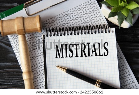 MISTRIALS - word on a white sheet on the background of a judge's gavel, a cactus and a pen