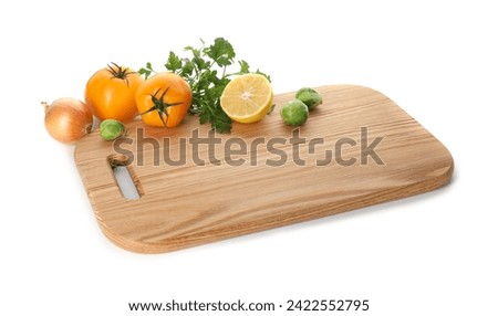 Wooden cutting board with different fresh vegetables isolated on white Royalty-Free Stock Photo #2422552795