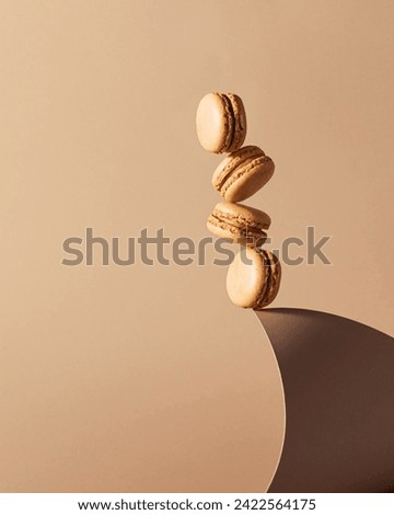 Beige monochrome background with balanced macaroons