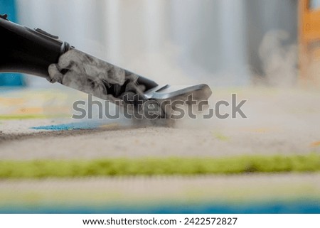 steam cleaning of the carpet in the children's room Royalty-Free Stock Photo #2422572827