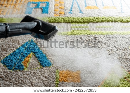 steam cleaning of the carpet in the children's room Royalty-Free Stock Photo #2422572853