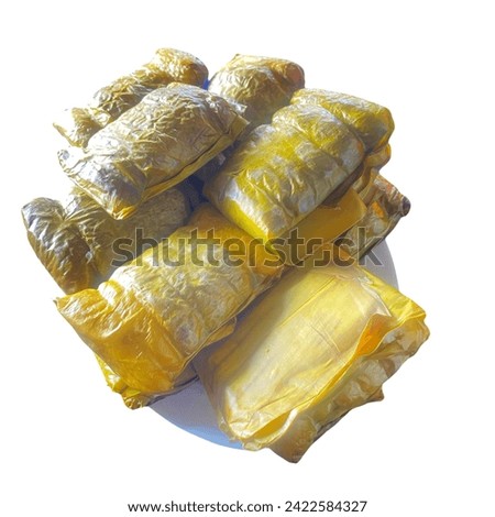 This food is called Buras, made from rice wrapped in leaves, and has a savory taste. typical food from the city of Makassar, South Sulawesi, Indonesia. Royalty-Free Stock Photo #2422584327