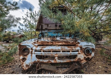 Old car on wrecking yard near Illinci village in Chernobyl Exclusion Zone in Ukraine Royalty-Free Stock Photo #2422587355