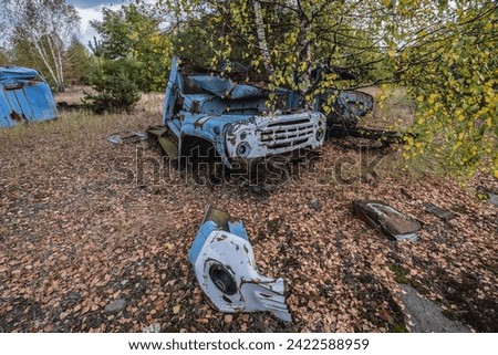 Old car on wrecking yard near Illinci village in Chernobyl Exclusion Zone in Ukraine Royalty-Free Stock Photo #2422588959
