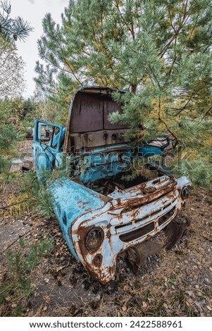 Old car on wrecking yard near Illinci village in Chernobyl Exclusion Zone in Ukraine Royalty-Free Stock Photo #2422588961