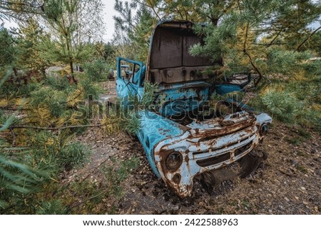 Old car on wrecking yard near Illinci village in Chernobyl Exclusion Zone in Ukraine Royalty-Free Stock Photo #2422588963
