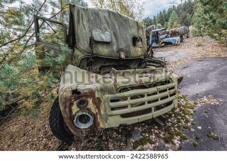 Old car on wrecking yard near Illinci village in Chernobyl Exclusion Zone, Ukraine Royalty-Free Stock Photo #2422588965