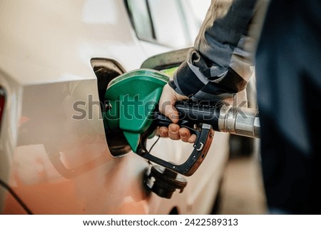 refueling the car at a gas station