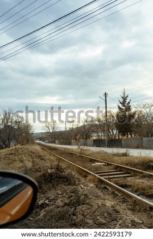 Railway with clouds, picture taken from car
