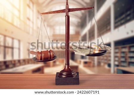 Wooden desk in courtroom, money and material concept Royalty-Free Stock Photo #2422607191