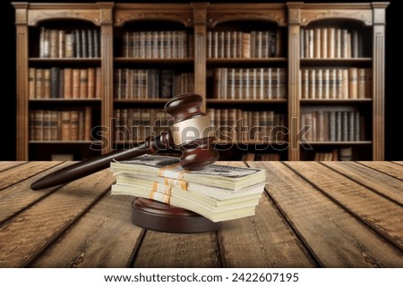 Wooden desk in courtroom, money and material concept Royalty-Free Stock Photo #2422607195