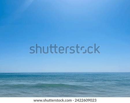 Blue sea horizon, sandy seashore, natural sea background, clear sky Royalty-Free Stock Photo #2422609023