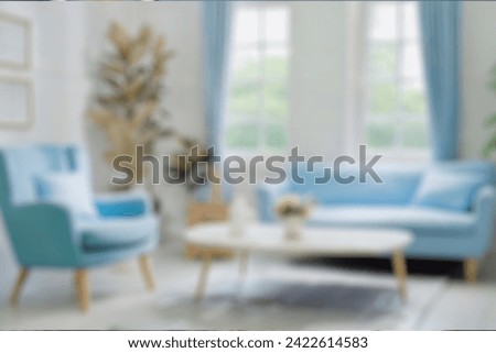 Blurred view of modern living room with sofa and soft bench. room interior with  couch, armchair and coffee table or shelving units. stylish living room. comfortable workplace near big window. Royalty-Free Stock Photo #2422614583