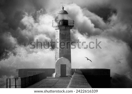 Old lighthouse against an enhanced cloudy stormy sky. Converted black and white. Added digital noise.