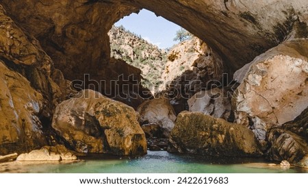 Tonto Natural Bridge: Arizona's hidden gem, a majestic limestone arch carved by nature's forces. A testament to time's artistry, inviting exploration in Tonto National Forest. Royalty-Free Stock Photo #2422619683