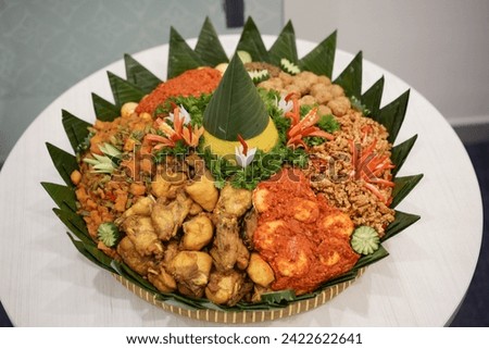 Tumpeng an Indonesian traditional cone-shaped rice dish with side dishes of vegetables and meat originating from Javanese cuisine of Indonesia. The picture was taken from above.