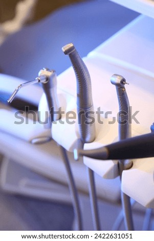 dentist tools and burnishers on a dentist chair in Dentist Clinic. Different dental instruments and tools in a dentists office. dentist and dental equipment in hospital	 Royalty-Free Stock Photo #2422631051