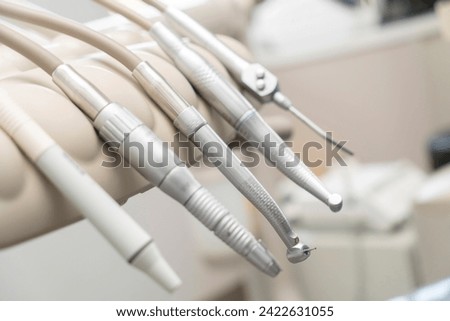 dentist tools and burnishers on a dentist chair in Dentist Clinic. Different dental instruments and tools in a dentists office. dentist and dental equipment in hospital	 Royalty-Free Stock Photo #2422631055