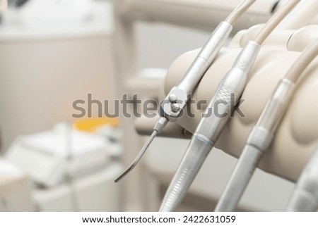 dentist tools and burnishers on a dentist chair in Dentist Clinic. Different dental instruments and tools in a dentists office. dentist and dental equipment in hospital	 Royalty-Free Stock Photo #2422631059
