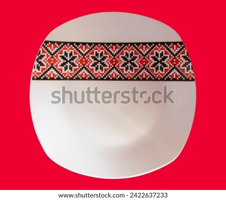 A white plate with traditional Romanian motifs, red with black, exudes elegance and distinct nostalgia. Each richly meaningful detail pays homage to Romanian traditions and culture, turning this plate