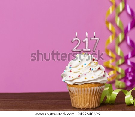 Birthday Cake With Candle Number 217 - On Pink Background.