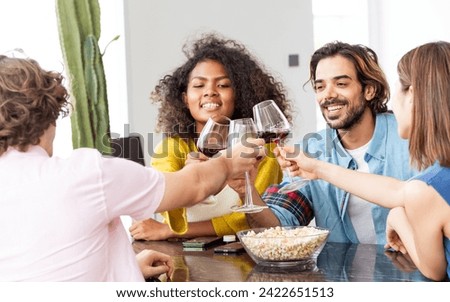 African afro woman, caucasian man wearing casual clothes, smiling with happiness, holding wine glass, toasting for party celebration at home with friends. Lifestyle, New Year, Birthday, Event Concept
