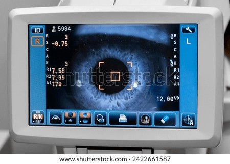Lady looking at refractometer eye testing machine in ophthalmology, tonometer, refractometer. Eye examination for glasses or lenses prescription. Ophthalmologist Ophthalmic Exam Concept. optometrist Royalty-Free Stock Photo #2422661587