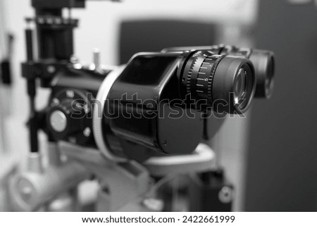 ophthalmic equipment placed in light contemporary optical shop for checking vision, slit lamp examination, ophthalmology concept, Slit lamp. Biomicroscope. Binoculars.	 Royalty-Free Stock Photo #2422661999