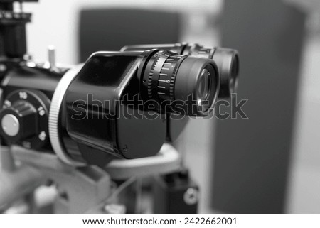 ophthalmic equipment placed in light contemporary optical shop for checking vision, slit lamp examination, ophthalmology concept, Slit lamp. Biomicroscope. Binoculars.	 Royalty-Free Stock Photo #2422662001