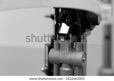 ophthalmic equipment placed in light contemporary optical shop for checking vision, slit lamp examination, ophthalmology concept, Slit lamp. Biomicroscope. Binoculars.	 Royalty-Free Stock Photo #2422662003