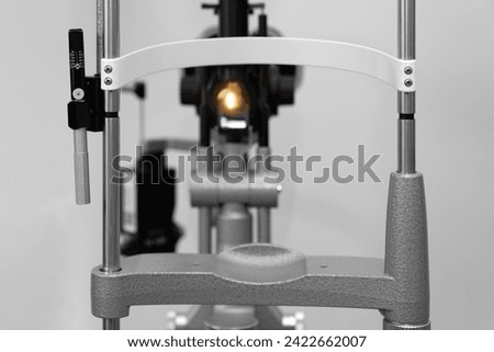ophthalmic equipment placed in light contemporary optical shop for checking vision, slit lamp examination, ophthalmology concept, Slit lamp. Biomicroscope. Binoculars.	 Royalty-Free Stock Photo #2422662007