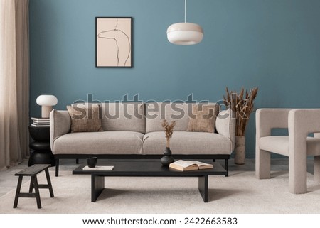 Creative composition of living room interior with mock up poster frame, grey sofa, black coffee table, blue wall, stylish furnitures, decorations and personal accessories. Template. Home decor.	

