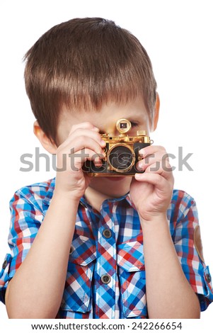 Little boy reporter photographer shooting with gold retro camera isolated close-up