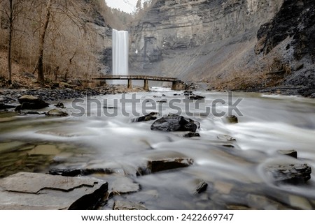 Long exposure winter photo of the Taughannock Falls and bridge at Taughannock Falls State Park near Ithaca NY.  (02-03-2024)