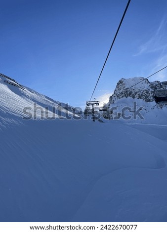 Heli-skiing and ski touring on a cloudless day with fresh powder Royalty-Free Stock Photo #2422670077