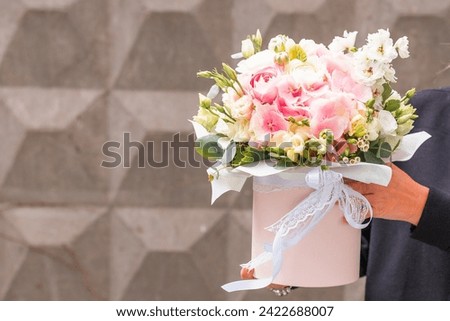 Tender flowers bouquet in pink box for present to woman’s day. Copy space