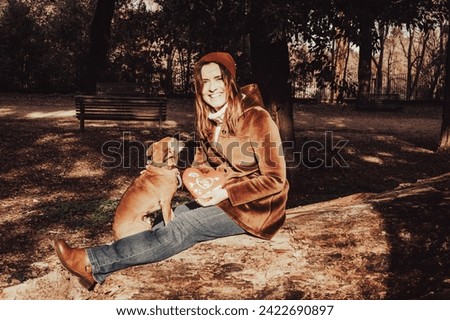 Smiling and happy woman while enjoying Valentine's day with her dog