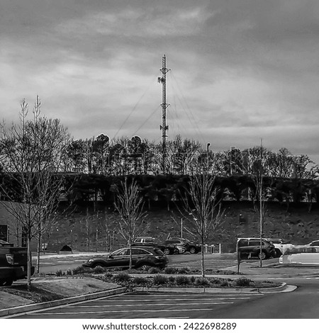 Carmine and Infrared filters on a photograph of a base station and antenna with a camouflaged parking lot in the foreground.