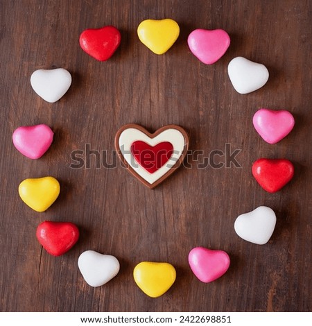 Valentine's Day is a cute and delicious sugar cookie with a pink heart and a sweet pattern on a wooden background. I love confectionery, sweets, baked goods, desserts.