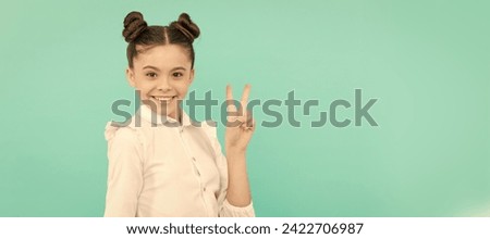Peace maker. School age kid show V sign. Happy kid blue background. Child face, horizontal poster, teenager girl isolated portrait, banner with copy space.
