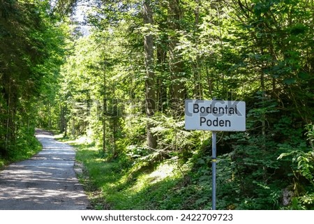 Road sign along scenic hiking trail through idyllic forest leading to alpine paradise Bodental (Poden), Carinthia, Austria. Remote alpine landscape in Austrian Alps in summer. Walking in wilderness