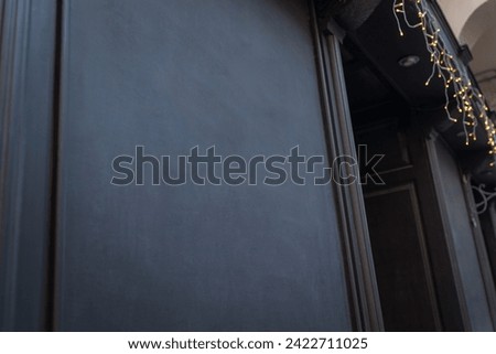 Black wooden board with free space for logo or text promotion at the entrance to a shop, cafe or restaurant