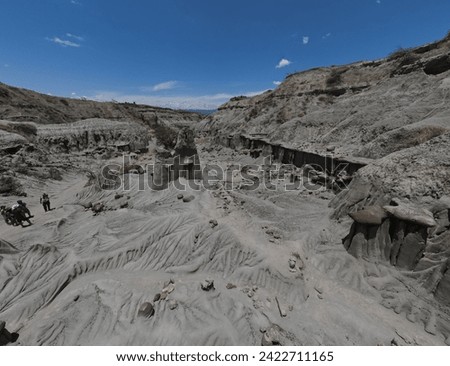 Aerial Majesty: Tatacoa's Vast Gray Expanse: As far as the eye can see, the gray desert of Tatacoa stretches under the drone's gaze, its barren beauty punctuated by rocky outcrops and winding gullies Royalty-Free Stock Photo #2422711165
