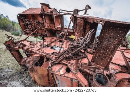 Combine harvester wrecking yard near Illinci village in Chernobyl Exclusion Zone in Ukraine Royalty-Free Stock Photo #2422720763