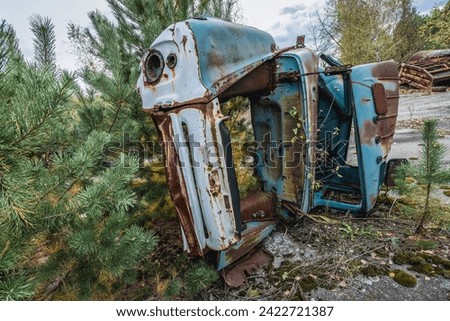 Old car on wrecking yard near Illinci village in Chernobyl Exclusion Zone in Ukraine Royalty-Free Stock Photo #2422721387