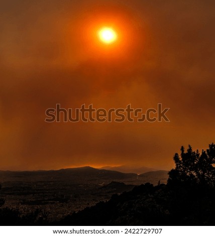 heavily edited landscape photo of Athens, Greece during a day where the sun shone incredibly heavily orange. Picture taken from Ymmitos mountain