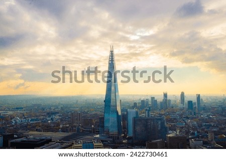 Panoramic sunset view from Sky Garden, London, featuring the Shard building amidst the cityscape. Urban beauty at dusk