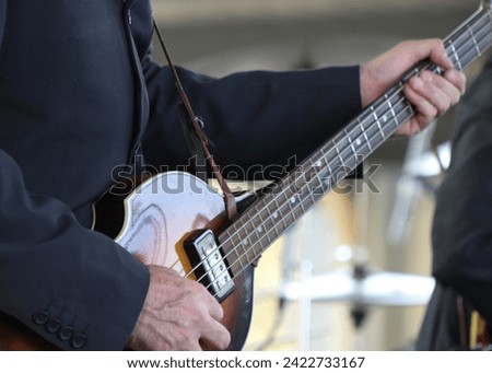 Close up of musicians playing vintage rock instruments